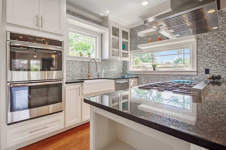 An image of a modern kitchen with sleek appliances, featuring a gas stove, refrigerator, and built-in microwave in Winchester